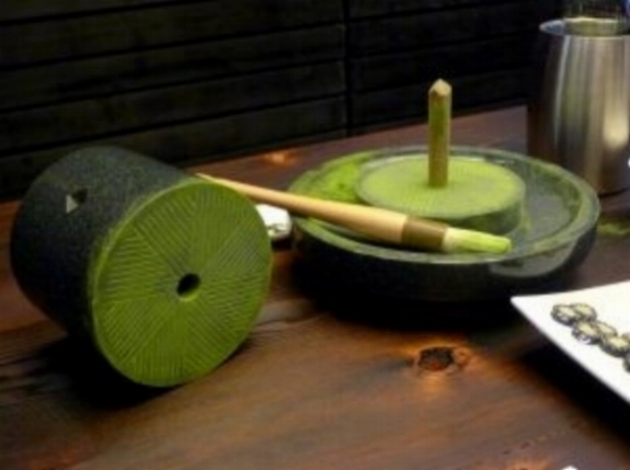 Traditional granite wheel used for hand-grinding matcha leaves into a fine powder